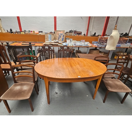 612 - An extending teak dining table and four chairs