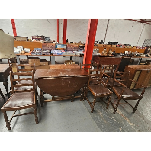 613 - An oak drop leaf dining table and six chairs