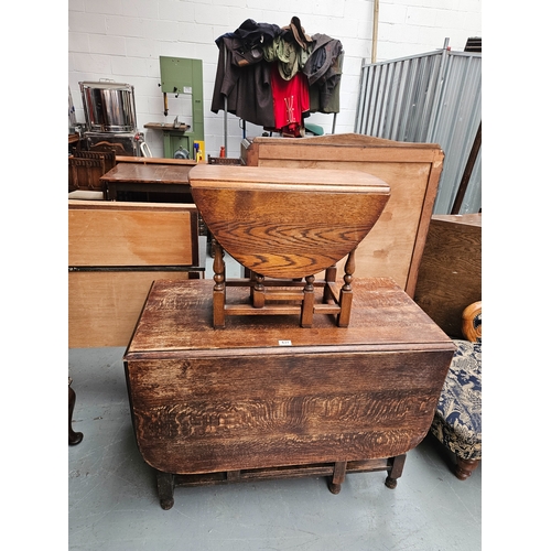 631 - An oak drop leaf dining table together with a small drop leaf coffee table