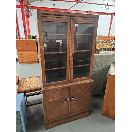 641 - An oak glazed bookcase with cupboard

Measurements: Height 166cm, Width 78cm, Depth 34cm