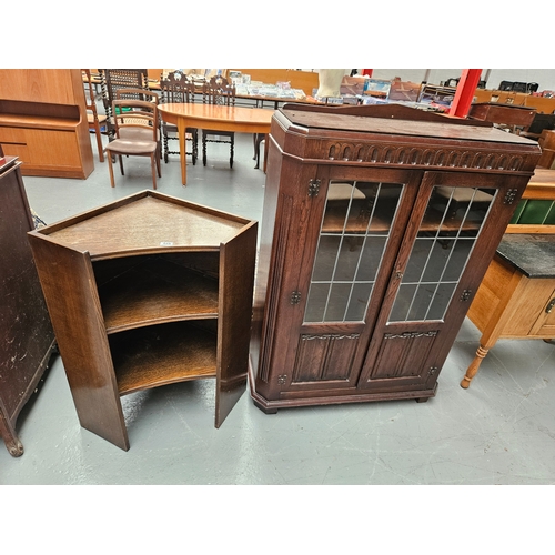 648 - An oak corner cabinet together with an oak bookcase