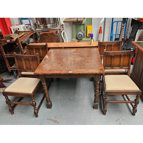 659 - An oak dining table together with 4 Ercol dining chairs