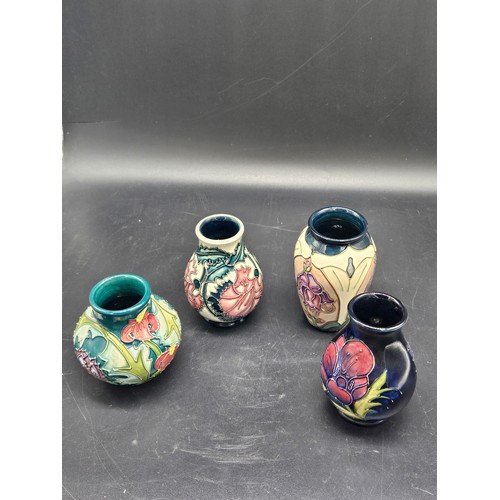 830 - Four small Moorcroft vases - Foxglove, Anemone, Trainee vase and Leicester patterns - average height... 