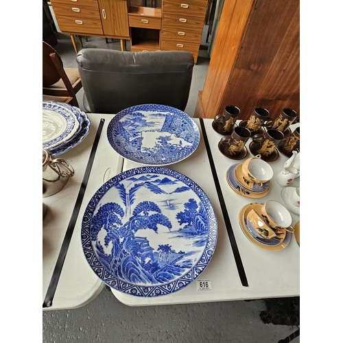 616 - Two large oriental blue and white plates with decoration to the reverse - approximate diameter is 15... 