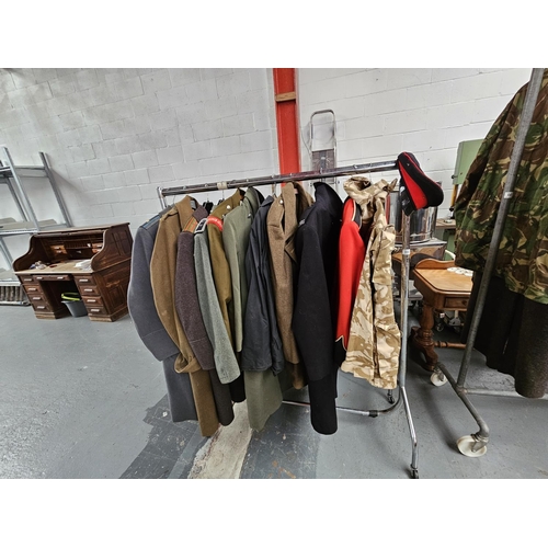 660 - A rail of military coats and jackets to include Great Coats, Royal Marines jacket and a military cap... 