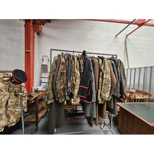 661 - A rail of military coats and jackets to include Great Coats, camouflage, etc (rail not included)