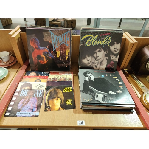 328 - A collection of vinyl records and singles to include Paul McCartney, Blondie, David Bowie, etc