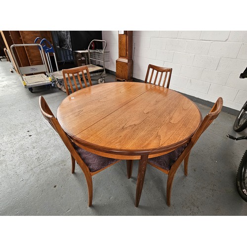 441 - A teak G Plan circular extending dining table with four chairs