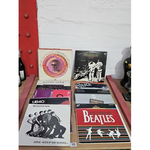 308 - A collection of vinyl records to include Madness, The Beatles, The Police etc