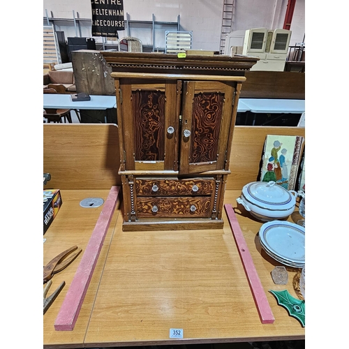 352 - A pine apprentice piece chiffonieur with two graduated drawers below cupboard with two doors