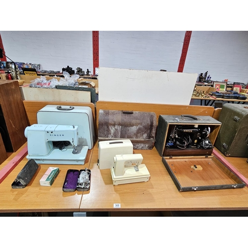 369 - Four Singer sewing machines with spare parts