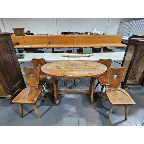 414 - A pine oval dining table with four chairs