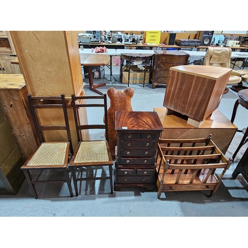 437 - A mahogany multi drawer chest, a pair of cane seated chairs, a hardwood Canterbury/magazine stand