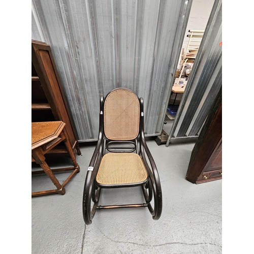 427 - A Thonet style bentwood rocking chair with woven seat and back