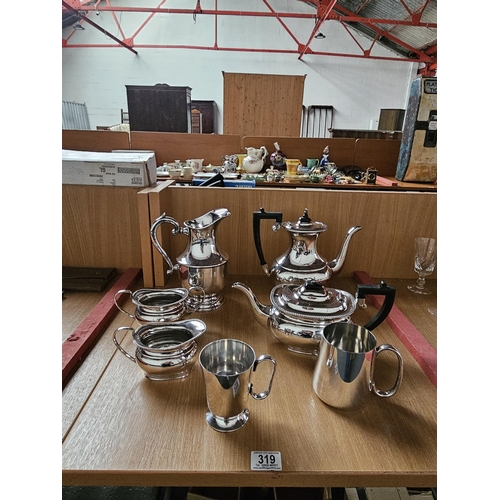 319 - A Sheffield silver plate tea/coffee set together with a silver plate water jug