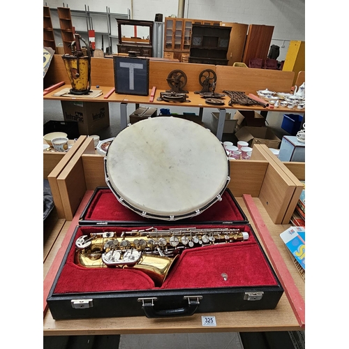 325 - A cased B & S Sonora saxophone together with a drum