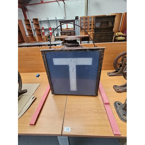 355 - A metal cased perspex ' T ' sign and Adlake track lamp.