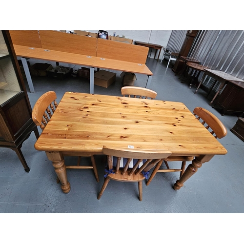 411 - A Pine dining table and four chairs