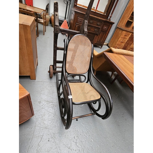 417 - A Thonet style bentwood rocking chair with woven seat and back