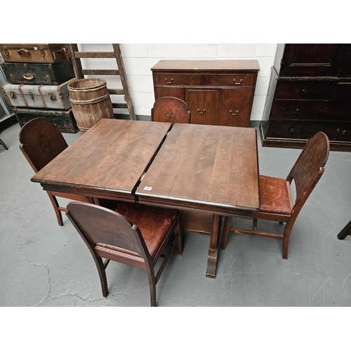 455 - An extending oak dining table and four chairs