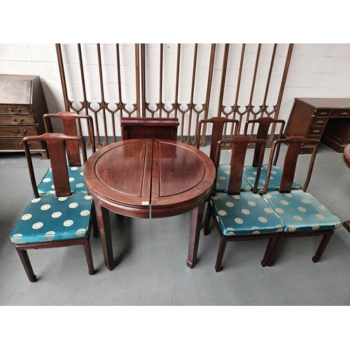 457 - A circular dining table with extra leaf and six matching chairs