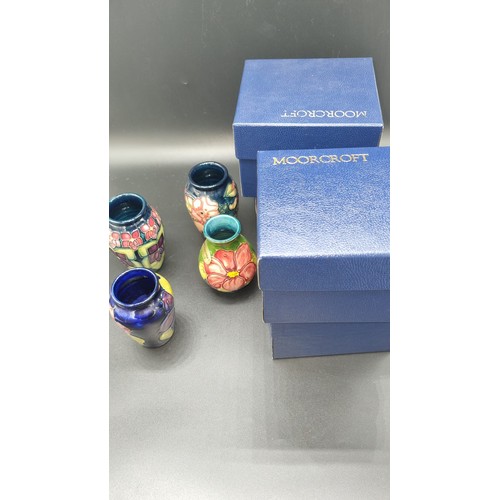 487 - Four small Moorcroft vases with original boxes - each vase approximately 4 inches high