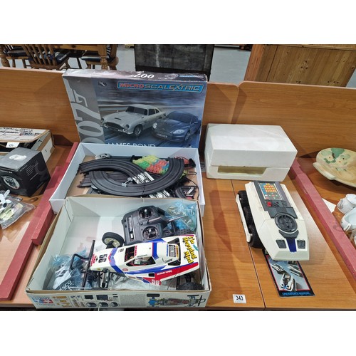 343 - A James Bond Aston Martin micro Scalextric set in box; The Grasshopper 2 radio controlled car in box... 