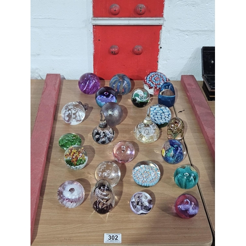 302 - Twenty three glass paperweights to include Caithness