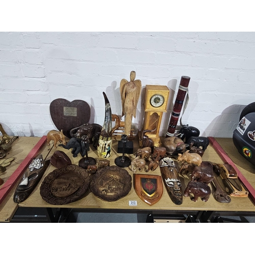 313 - A selection of wooden elephant ornaments, clock, plaques etc