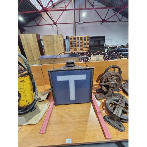 354 - A metal cased perspex ' T ' sign and Adlake track lamp.