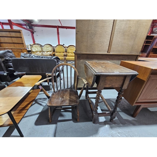 429 - An oak drop leaf table on barley twist supports and an armchair