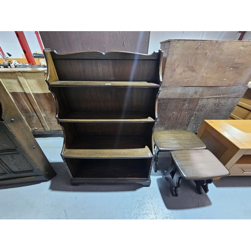 437 - A dark Ercol bookcase and nest of tables