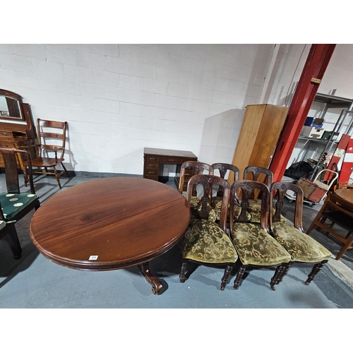 454 - A Victorian circular tilt top table and six chairs