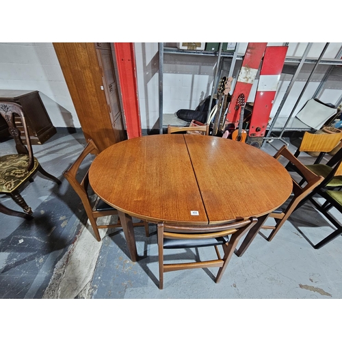 455 - An oval teak extending dining table and four chairs