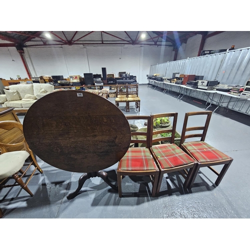 440 - A tilt top dining table on tripod base together with three Oak dining chairs