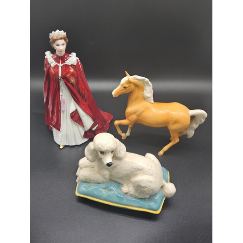 500 - A Beswick horse, Royal Doulton figure of a poodle laying on a cushion and a Royal Worcester figurine... 