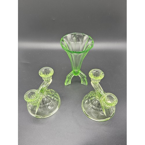 501 - A uranium glass dressing table set (chip to one lid) together with a uranium glass vase