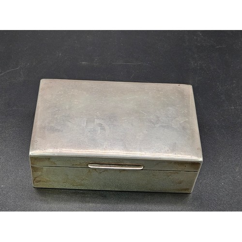 519 - A hallmarked silver cigarette box - hallmarks for London - 1927 - William Comyns and Son - weight in... 