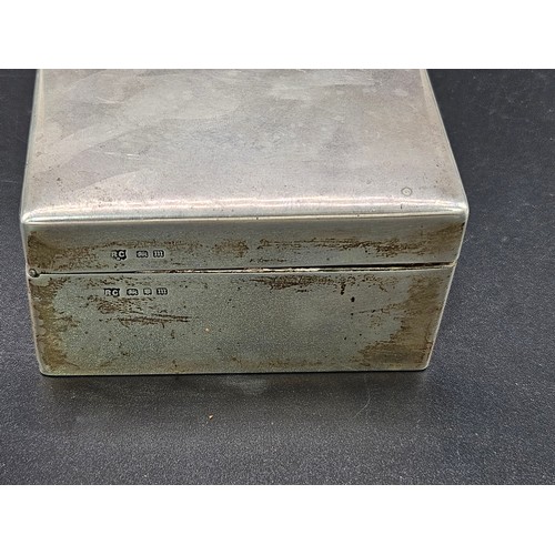 519 - A hallmarked silver cigarette box - hallmarks for London - 1927 - William Comyns and Son - weight in... 