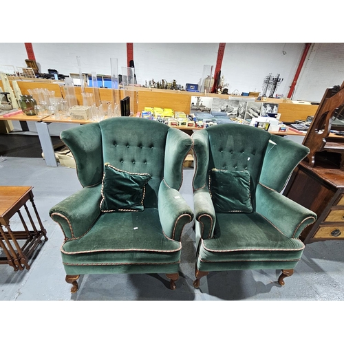 404 - A pair of upholstered wingback armchairs