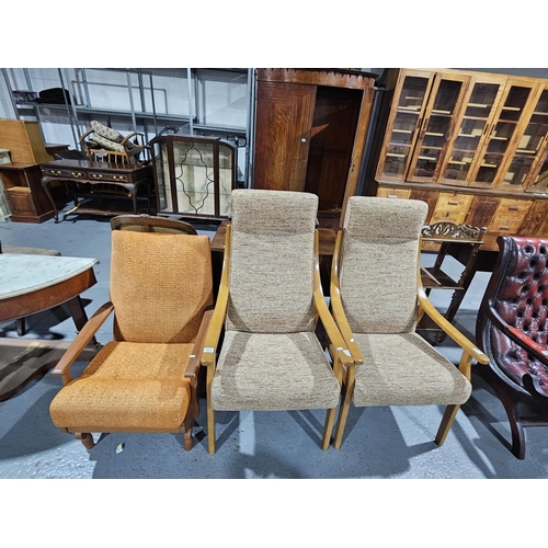 422 - Two Mid century style armchairs together with a Mid century style rocking chair