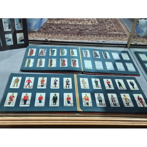 511 - Three albums containing cigarette cards - shipping, botanical, trains, sporting, etc