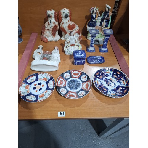 369 - A pair of Staffordshire dogs, three Staffordshire flat backs, three Imari plates and other blue and ... 