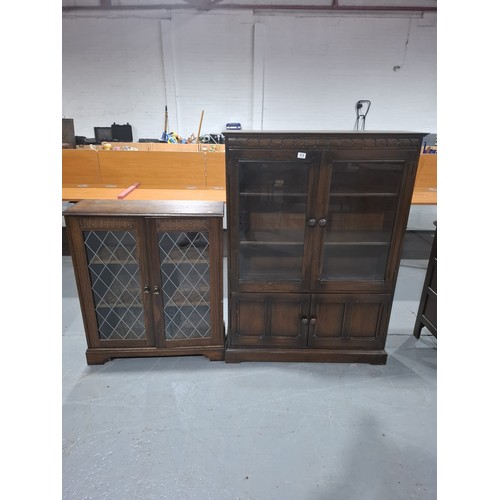 414 - An oak glass fronted bookcase together with one other bookcase