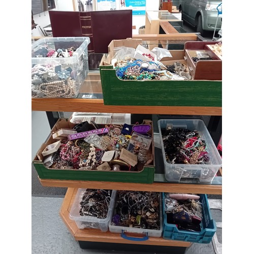 522 - A large quantity of Costume jewellery displayed over three shelves