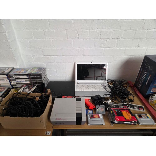 513 - A Playstation 2 and 3 console, Nintendo Nes version console with an assortment of leads and Playstat... 