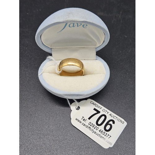 706 - An 18 carat gold wedding band - weight 6.6 grams