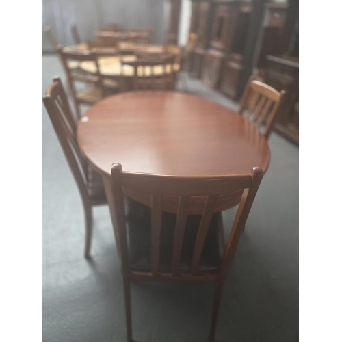654 - A teak circular dining table and four chairs