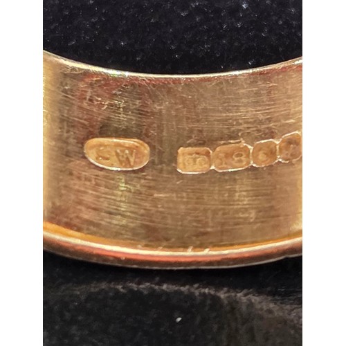 717 - An 18 carat gold dress ring with green stone - weight including stone 13 grams