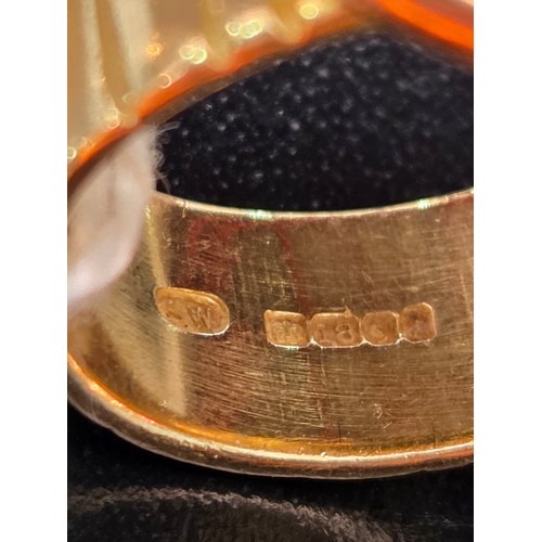 717 - An 18 carat gold dress ring with green stone - weight including stone 13 grams